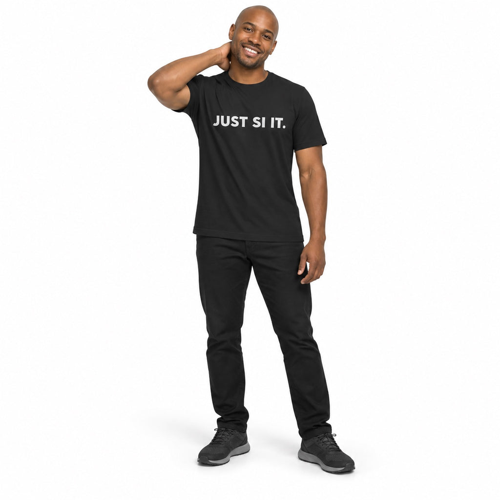 Full-body man wearing the dark grey JUST SI IT. t-shirt with white chest lettering and grey trainers, hand behind his neck on a white background.