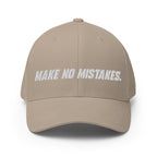 Front view of the khaki MAKE NO MISTAKES. cap with white embroidered lettering and a curved visor.