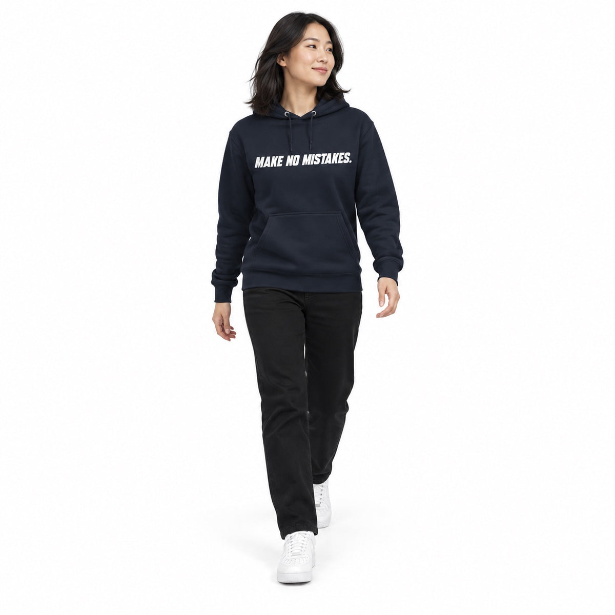 Full-body model wearing the navy blazer MAKE NO MISTAKES. hoodie with white chest print, stepping forward with relaxed arms on a plain white background.