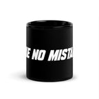Front view of the black 11 oz MAKE NO MISTAKES. ceramic mug with bold white lettering and a glossy finish.
