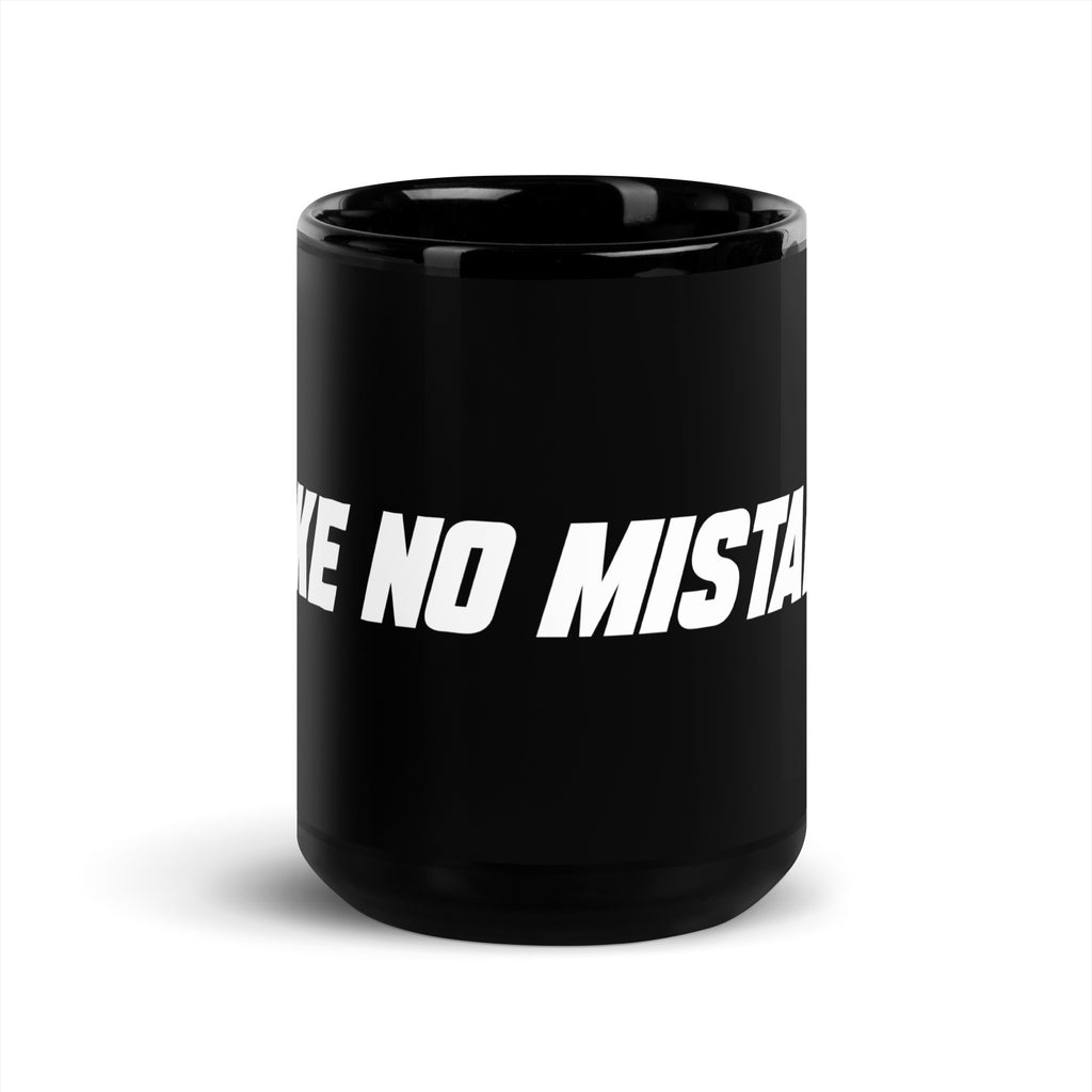 Front view of the black 15 oz MAKE NO MISTAKES. ceramic mug with bold white wraparound lettering and a glossy finish.