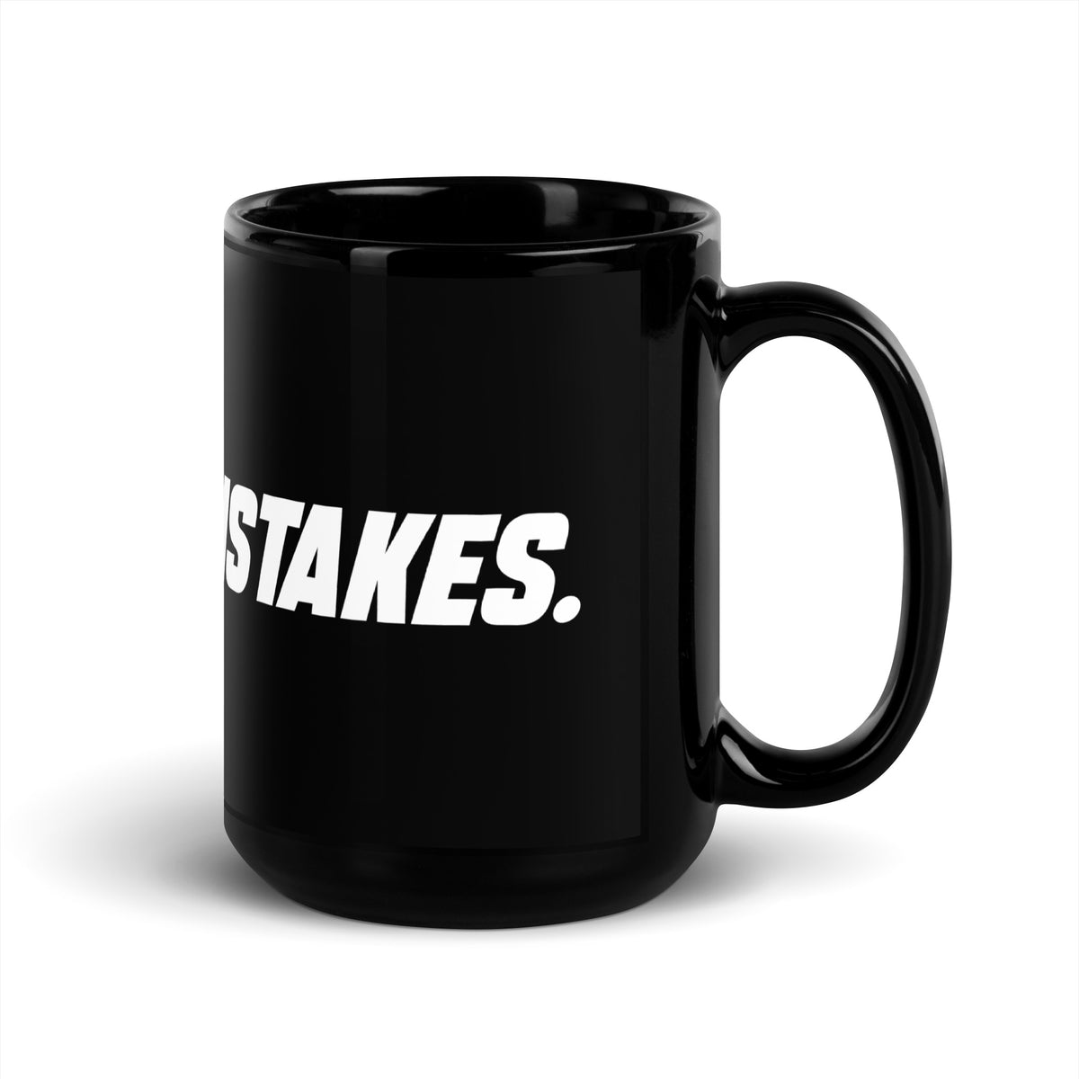 Black 15 oz MAKE NO MISTAKES. ceramic mug viewed with the curved handle on the right, showing its tall glossy body and white wraparound print.