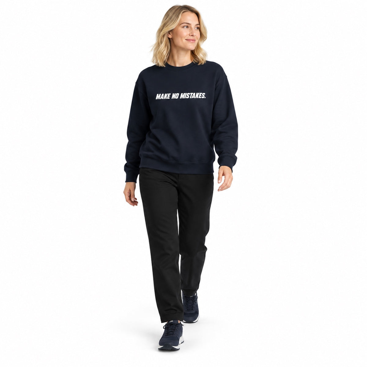 Full-body blonde woman wearing the navy blazer MAKE NO MISTAKES. sweatshirt with white chest print and navy trainers, stepping forward on a white background.