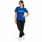 Full-body model wearing the true royal MAKE NO MISTAKES. T-shirt with white chest print, standing with crossed ankles and one hand on her hip on a white background.