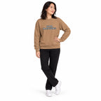 Full-body model wearing the latte beige Super Intelligence sweatshirt with a two-line chest print, one hand on her hip and ankles crossed on a white background.
