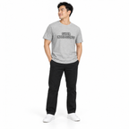 Full-body model wearing the athletic heather Super Intelligence T-shirt with the front graphic visible, standing with hands in trouser pockets on a plain white background.
